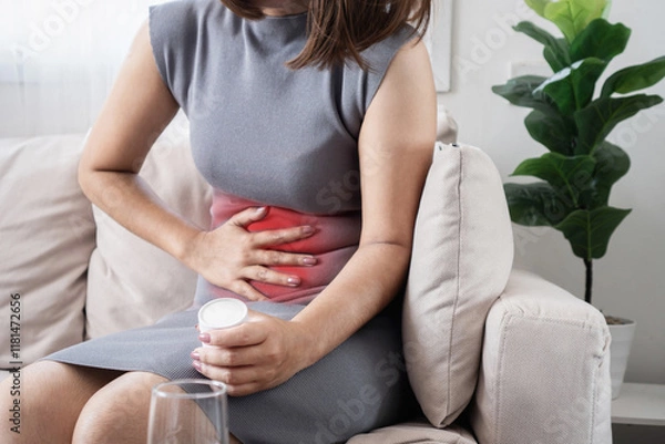 Fototapeta woman suffering from abdominal cramps and diarrhea, potential symptoms of Gastroenteritis or Helicobacter pylori infection