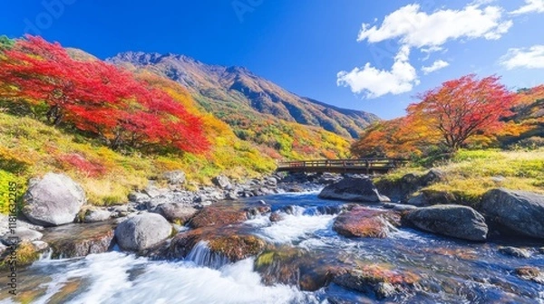 Fototapeta Autumnal Mountain Stream with Bridge and Vivid Foliage
