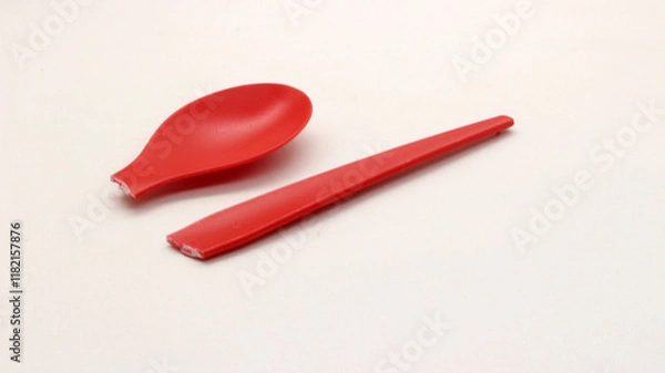 Fototapeta Broken red plastic spoon isolated