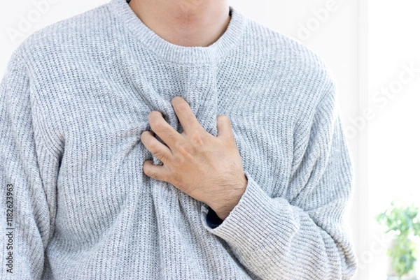 Obraz 胸を押さえて苦しむセーターを着た男性（30代、日本人、顔無し）
