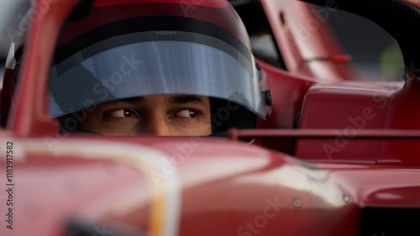 Fototapeta Close-up of a focused pilot driver in a red racing car, preparing for a race