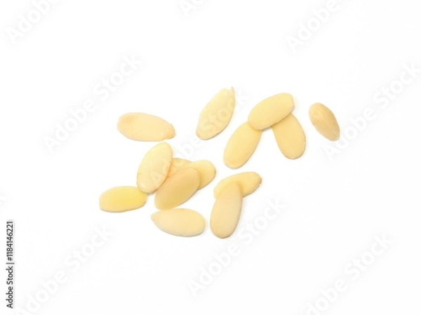 Obraz Heap of raw almond flakes isolated on white background. Sliced almonds pile.  Peeled or hulled almond slices pile isolated.