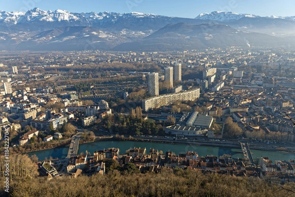 Fototapeta Grenoble city center and snowy mountains range as seen from the fortress of La Bastille