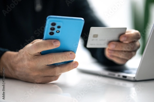 Fototapeta Man using credit card and paying via mobile banking app. Internet payment, online shopping, concept.