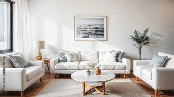 Fototapeta A minimalist living room featuring a white sofa, matching cushions, and wooden side tables with dome lamps. A black and white coastal photograph hangs above the sofa.