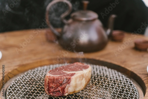 Fototapeta A piece of meat is on a metal pan