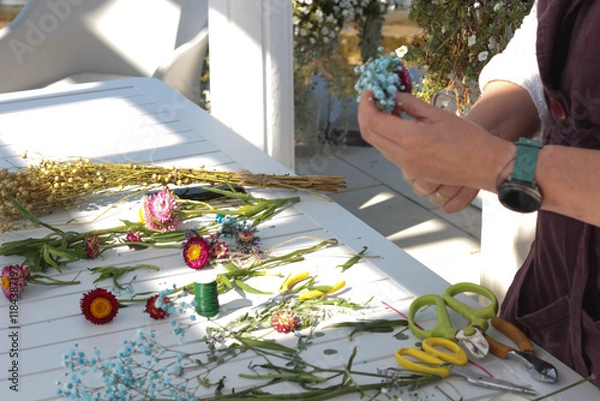 Fototapeta Woman making fashion modern bouquet of different flowers stock photo. Summer day