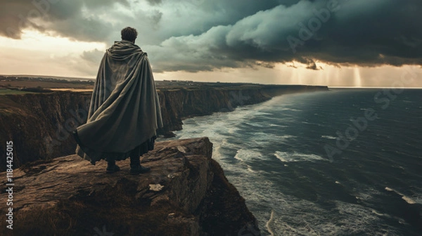 Fototapeta A knight stands at the edge of a cliff overlooking a turbulent sea. The wind blows fiercely, and his sword is held firmly at his side. His face remains hidden under his helm, conveying a sense of unwa