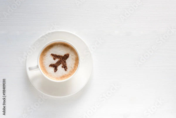 Fototapeta Airplane made of cinnamon in coffee. Cup of coffee with aircraft. Traveling concept. Cappuccino in airport