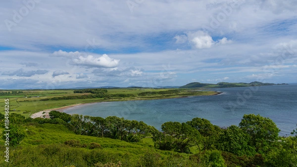 Fototapeta Scalpsie Bay, Isle of Bute, Scotland - June 8, 2024: A breathtaking coastal landscape featuring the tranquil Scalpsie Bay on the Isle of Bute. 