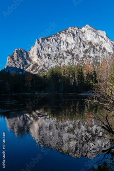 Obraz Lake Kreuzteich surrounded by mountain peak Pribitz in Hochschwab Alps in Tragoess, Styria, Austria. Forest in vibrant autumn foliage. Crystal-clear water reflects majestic ridges. Mirror-like effect