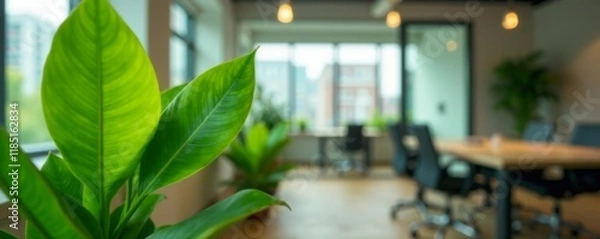 Obraz Close-up of lush green plant with subtle blur effect of surrounding office lighting and furniture, indoor plants, natural elements, green plant