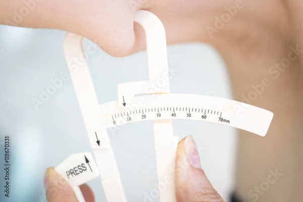 Obraz Fat caliper measuring bodyfat