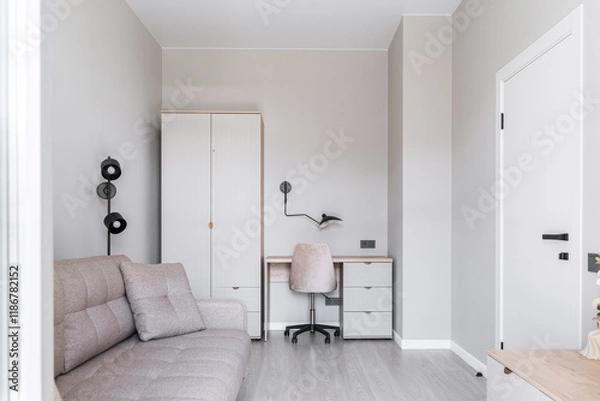 Fototapeta cozy office in bright colors. Living room design. room has table, chair, table lamp and wardrobe, soft beige sofa, floor lamp. White doors. Architecture inside. Space for relaxation, moments of calm.