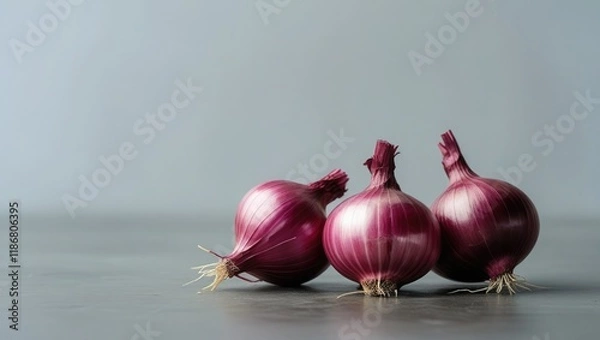 Fototapeta An lonely set of fresh red onions against a clear backdrop. The idea of healthy veggies