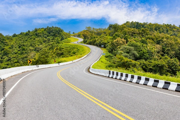 Fototapeta Popular view point of double s-curve road up to the hill with green tree and sky, called curve number 3 at Nan province, Northern of Thailand