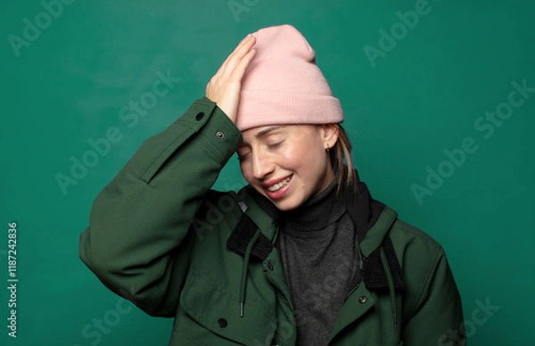 Fototapeta laughing and slapping forehead like saying d’oh! I forgot or that was a stupid mistake