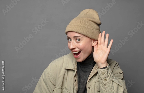 Fototapeta looking happy, listening, trying to hear a secret conversation or gossip, eavesdropping