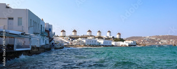 Fototapeta Mykonos horizontal banner with the famous windmills overlooking the mediterranean sea.