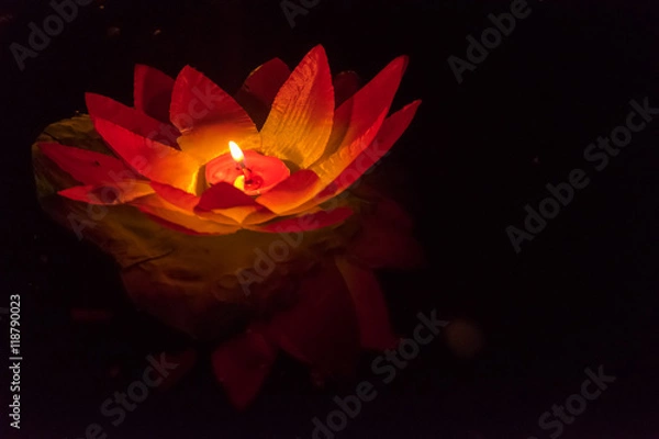 Fototapeta Floating paper lanterns on the water at night