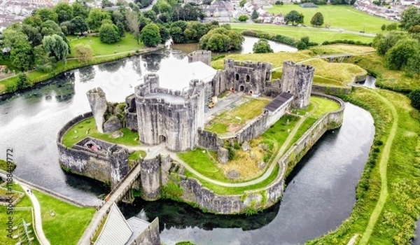 Fototapeta Aerial View of a Historic Caerphilly Castle Surrounded by a Reflective Moat