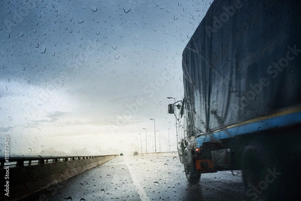 Fototapeta Bad weather conditions on the road during rain storm ,view through the wind shield of rainy day.Selective focus and color toned.