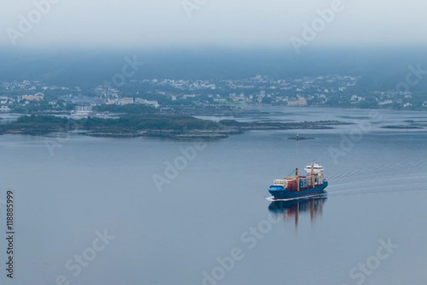 Obraz Unknown destination / Industrial ship going to the sea in a foggy day. Ålesund, Norway.