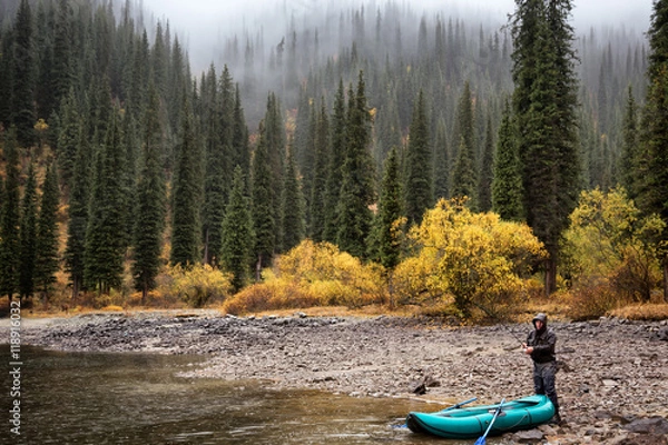 Fototapeta Autumn fishing after snowfall on the lake Kolsai, Kazakhstan