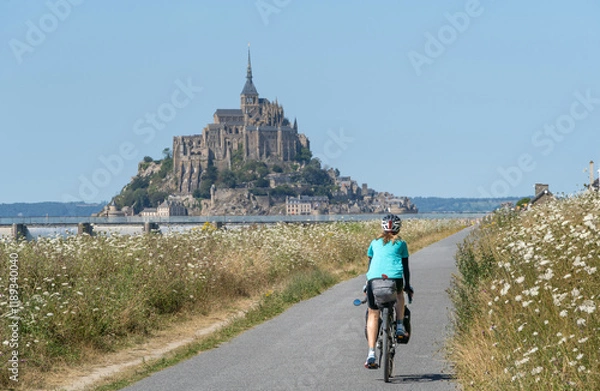 Obraz Solo female traveler cycling around mount San Michele.