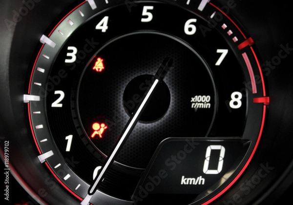 Fototapeta Macro shot tachometer with glowing needle indicate engine revolutions and zero speed
