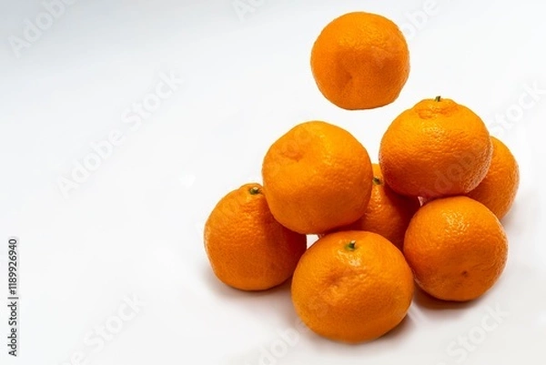 Fototapeta Fresh, ripe tangerines on a white background.