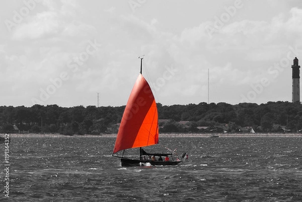 Fototapeta red and black study of a sailboat sailing on the Arcachon basin, in the southwest of France in the Aquitaine region