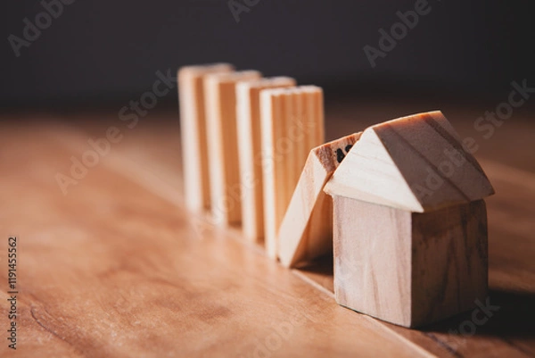 Fototapeta wooden model house and wooden blocks on black background with copy space.