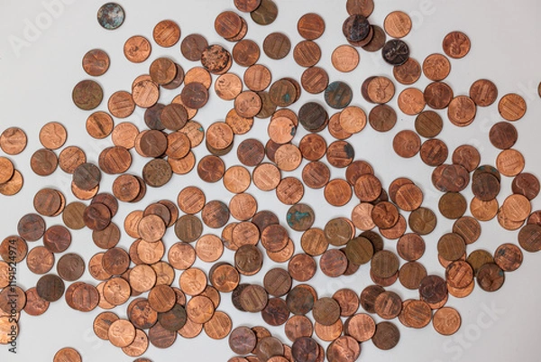 Obraz Scattered copper coins on a white background.