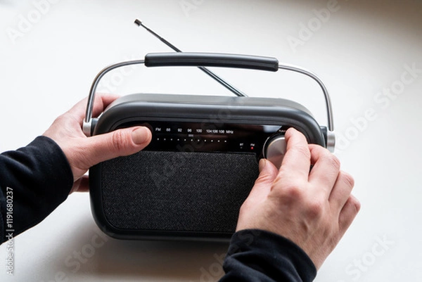 Fototapeta CLose up of  female hands tuning old fashion style radio set