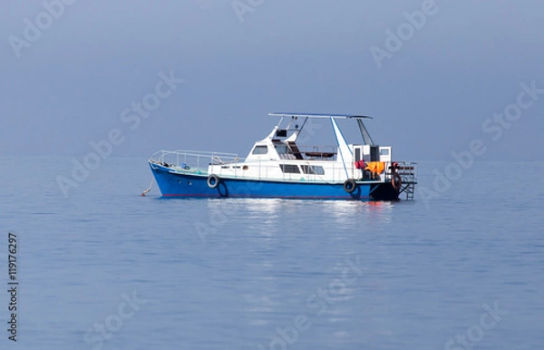 Fototapeta boat on the surface of the water in the sea