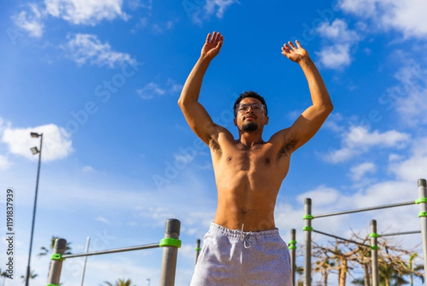 Obraz A man is warming up during his workout outroors
