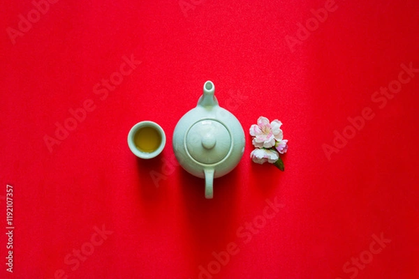 Fototapeta Tea set and peach blossom on red cloth background for Chinese new year concept.
