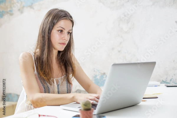 Fototapeta Young woman with laptop