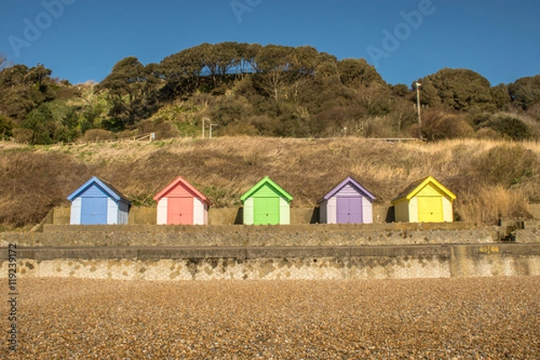 Fototapeta Bright and colourful wooden beach huts on coastal promenade between Folkestone and Sandgate in Kent