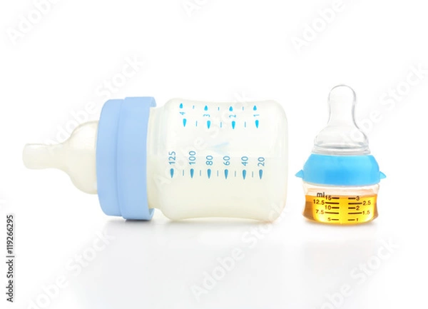 Fototapeta Feeding bottle with baby milk formula and bottle with medicine on white background