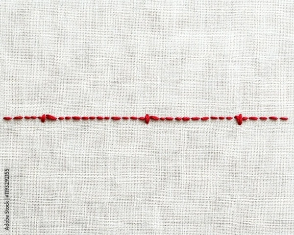 Obraz Red thread sewing pattern on a linen fabric.