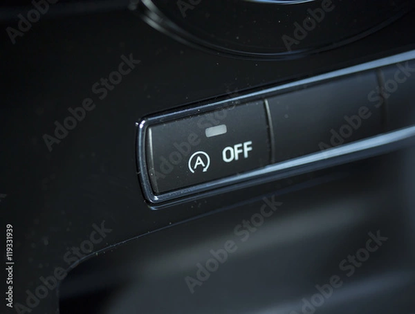 Fototapeta Automatic start and stop function button. The button is from a new modern car.