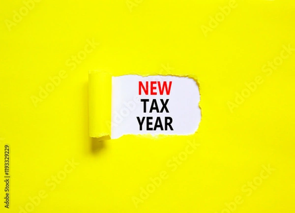 Fototapeta New tax year symbol. Concept words New tax year on beautiful white paper. Beautiful yellow table yellow background. Business new tax year concept. Copy space.