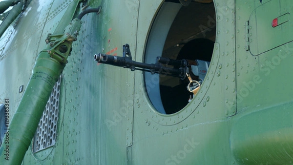 Fototapeta machine gun mounted in the window of a military helicopter