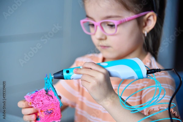 Obraz Child plays with a 3D pen. The girl creates a 3D toy.
