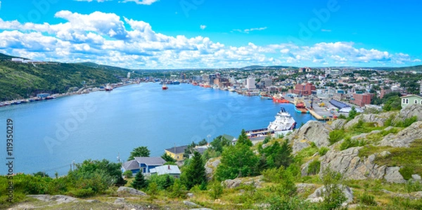 Fototapeta Panoramic views with bight blue summer day sky with puffy clouds over the harbour and city of St. John's Newfoundland, Canada.