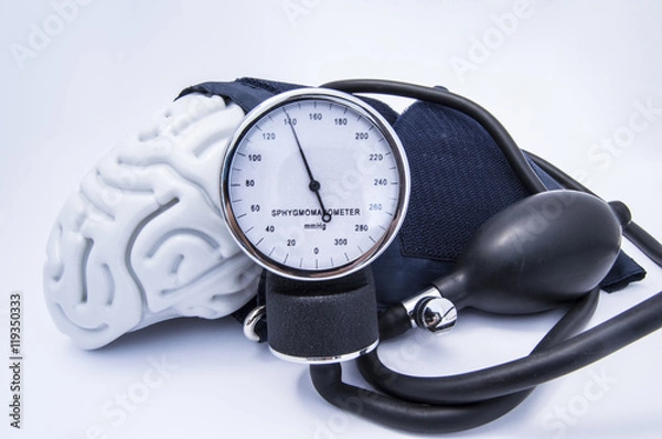 Fototapeta The figure of the human brain enveloped sphygmomanometer cuff with bulb (pear) and dial showing high blood pressure. Concept high brain or increased (raised) intracranial pressure (hypertension)