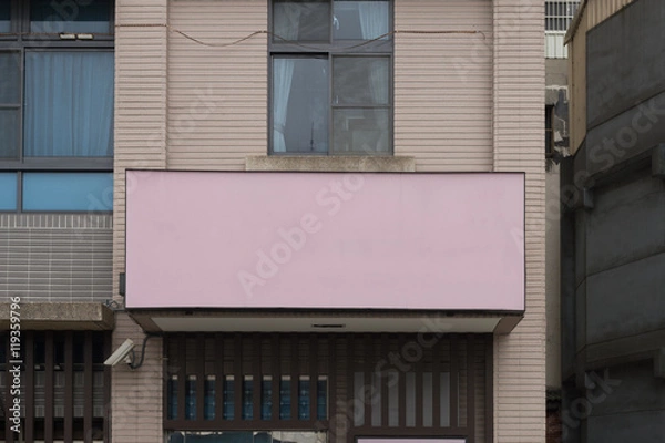 Fototapeta Large blank billboard on a street wall, banners with room to add your own text