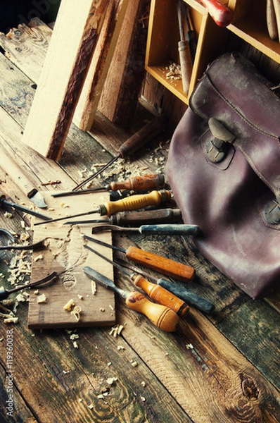 Obraz Chisels and carved piece of wood in traditional carpenter workshop
